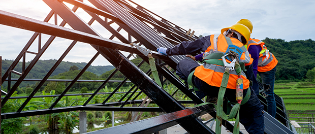 Roofer worker in protective uniform wear and gloves