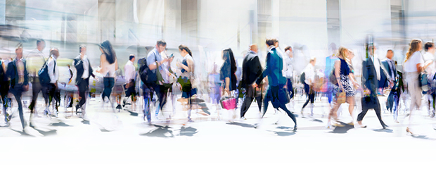 Walking people blur. Lots of people walking in the City of London. Wide panoramic view of people crossing the road.