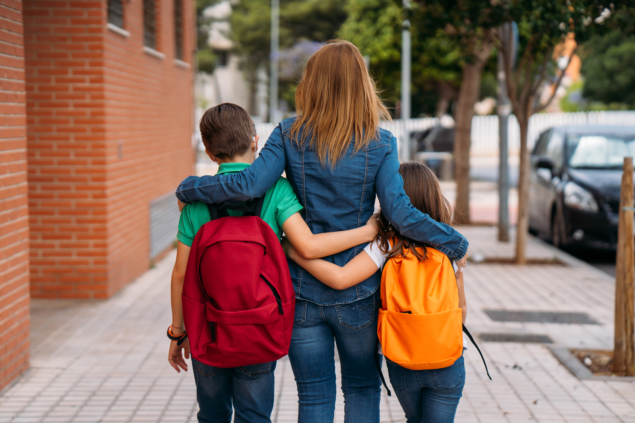 Madre llevando a sus hijos al colegio